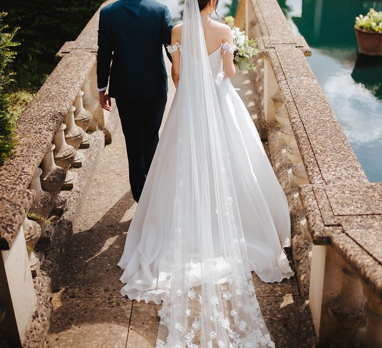 Bride & groom walk down steps arm in arm on their wedding day