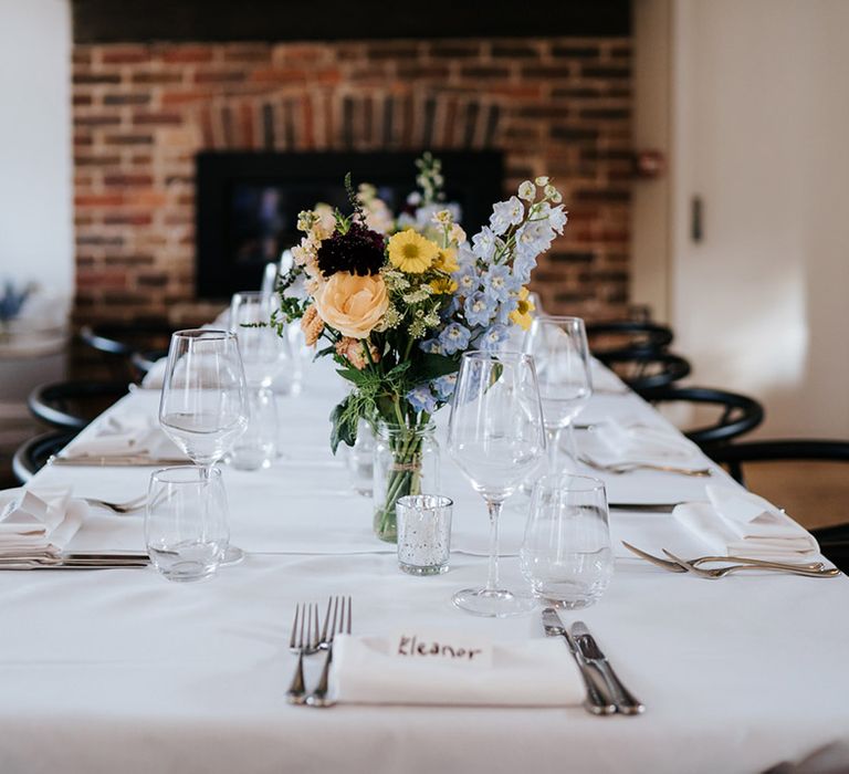 Elegant and classic wedding reception table complete with bright florals