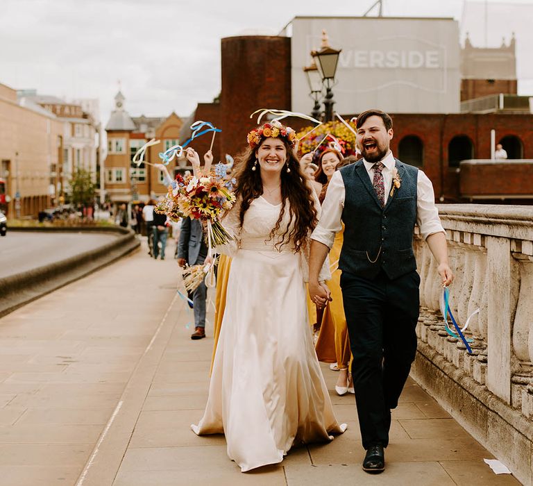 Bride wears custom made wedding gown complete with floral crown