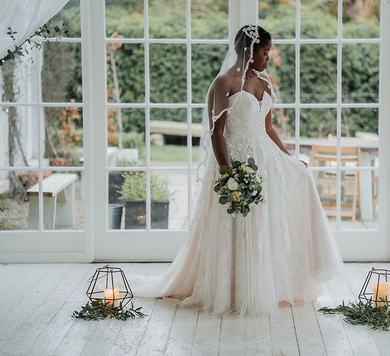 Gorgeous Bride wears chiffon layered wedding dress and lace edge veil at rustic classic wedding 