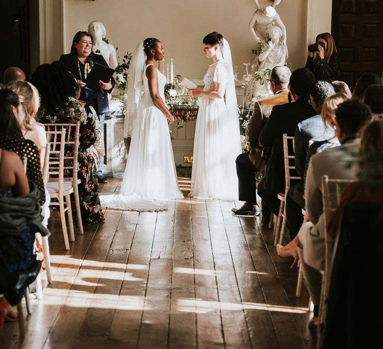 Bride and bride exchanging vows at their same-sex civil wedding ceremony at Elmore Court wedding venue 