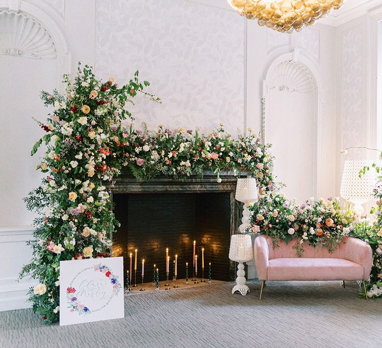 Barnett Hill Hotel drawing room with fireplace flower, column arrangement and pink velvet sofa 