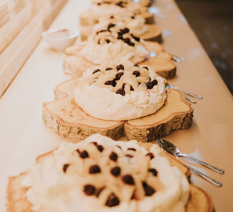 Wedding desserts for guests with meringue, cream and berries in kind of pavolva style