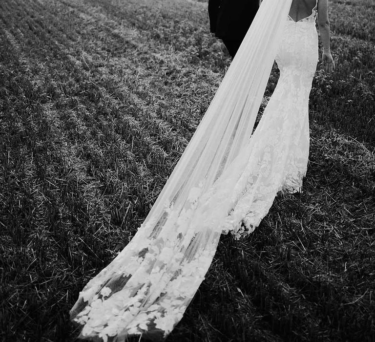 Bride and groom walk around the grounds of their wedding venue