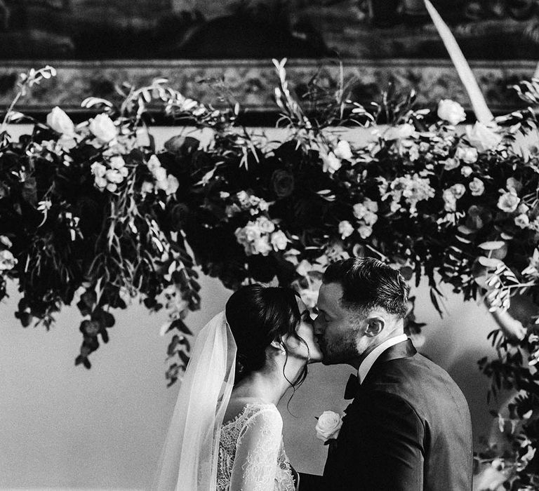 The bride and groom share their first kiss as a married couple 