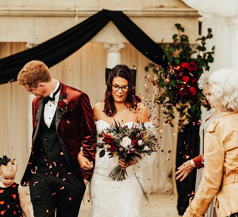 Confetti exit for the bride and groom as they walk back down the aisle as husband and wife 