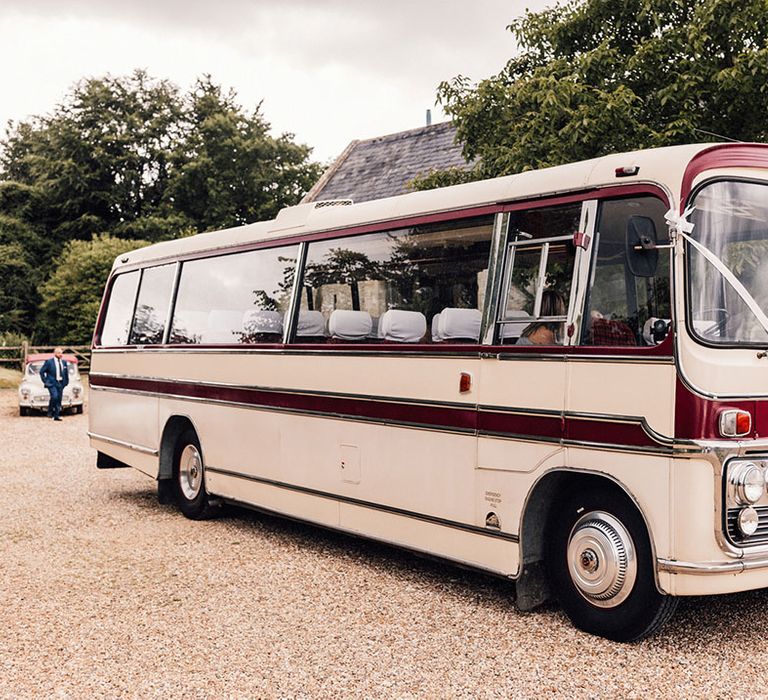 Wedding coach to transport the wedding guests decorated with a classic white ribbon 