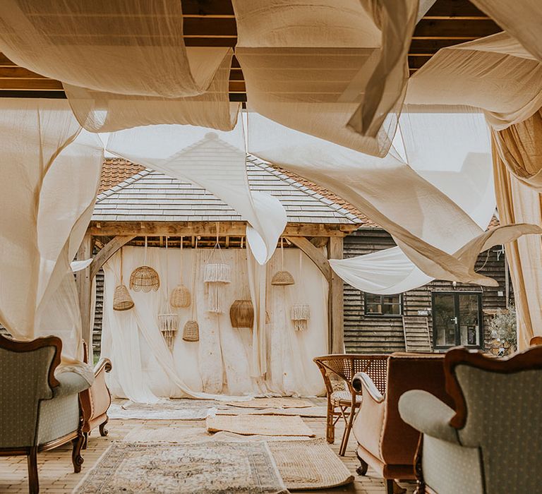 boho wedding inspiration at The Canary Shed with hanging drapes, Persian rugs, macrame and wicker lampshade decor 