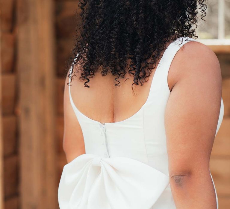 Bride in bow back satin wedding dress at Rackleys Barn editorial shoot