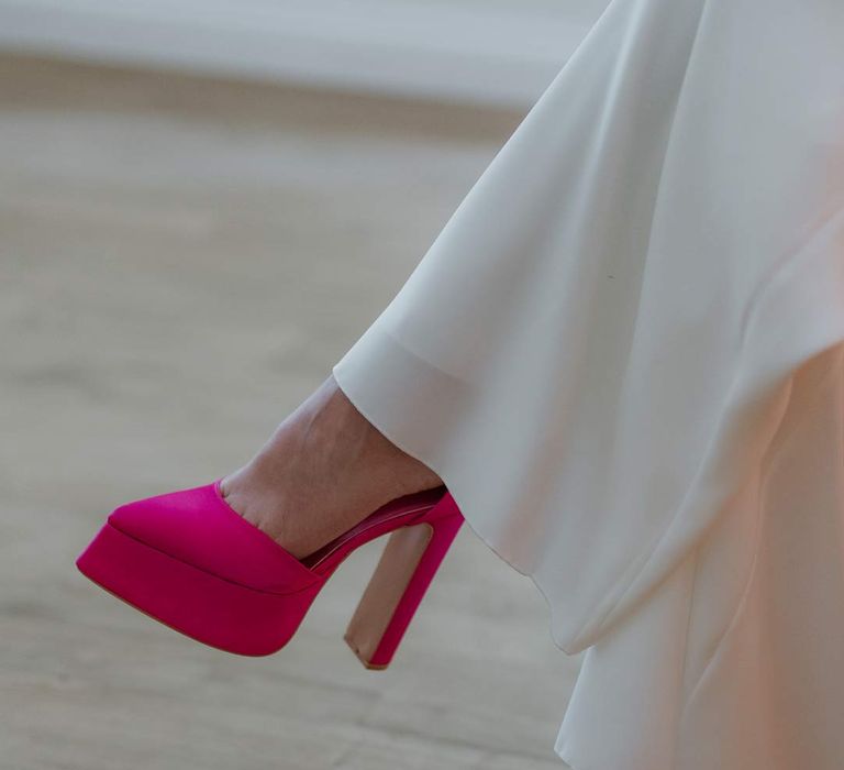 Bride wearing large pink platform wedding heels at pink and orange wedding at The Old Rectory 