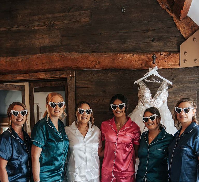 Bridal party in satin pyjamas and retro heart sunglasses