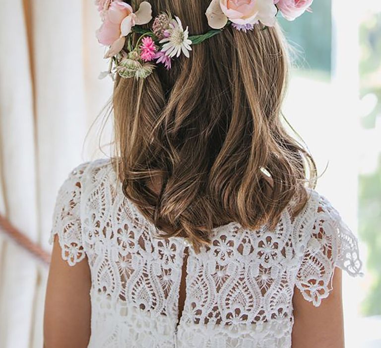 Young girl wearing a flower crown facing away from camera