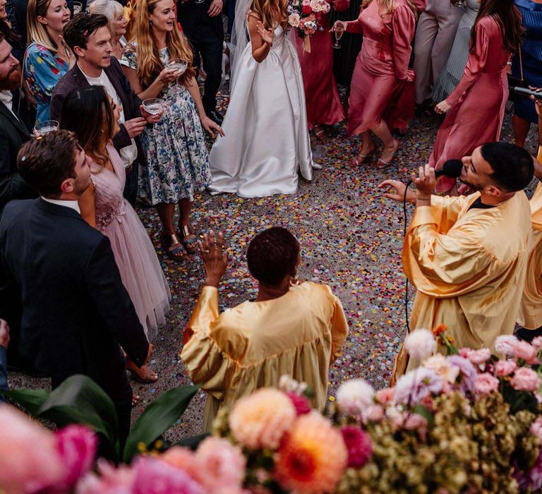 Choir flash mob at wedding ceremony with bridal party and guests involved for wedding entertainment