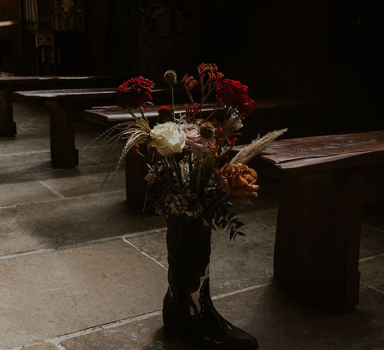 Cowboy boot filled with flowers for the aisle decoration at Western theme wedding 