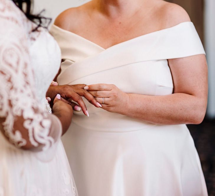 Newly wed lesbian couple holding hands at their Liverpool wedding