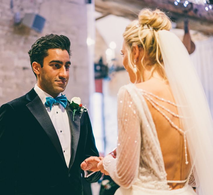 Bride and groom exchanging vows at Christmas wedding 