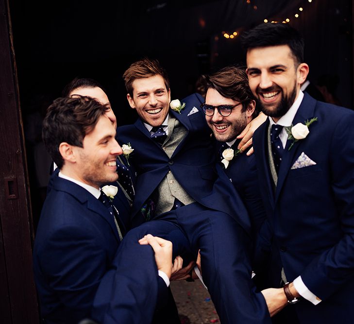 Groomsmen wearing navy wedding suits 