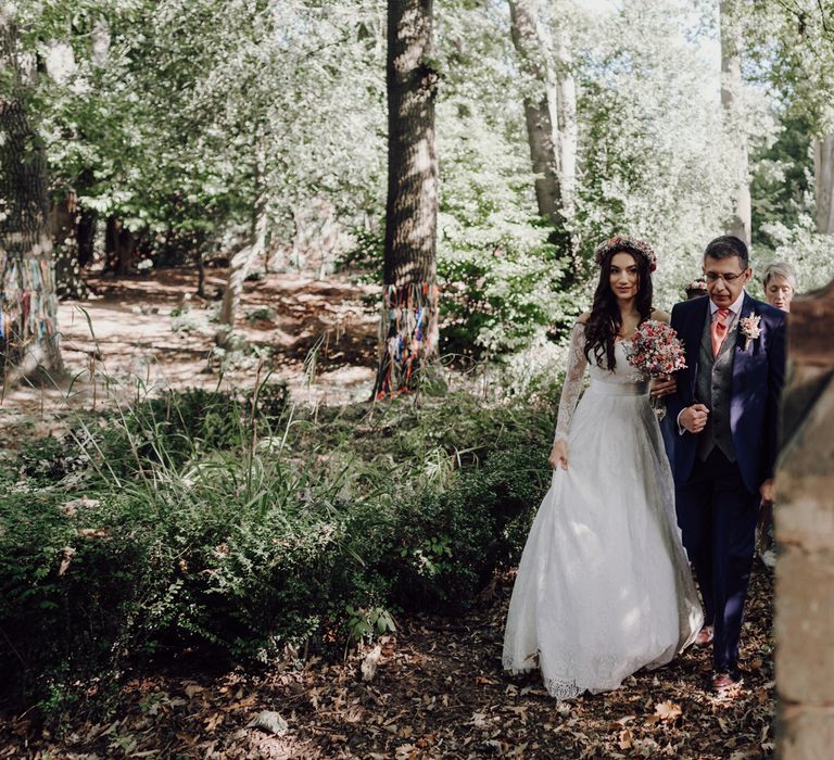 Bride walks with her dad to wedding ceremony wearing ASOS bridal dress