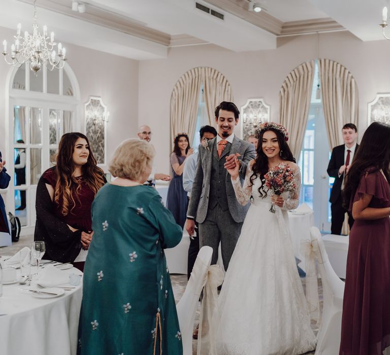 Bride and groom enter wedding breakfast