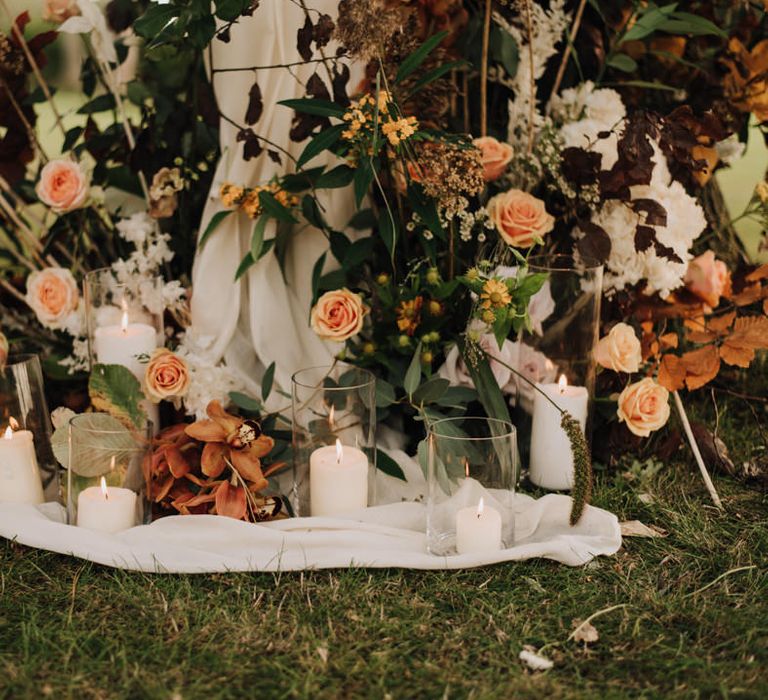 Orange and gold toned wedding flowers at the altar