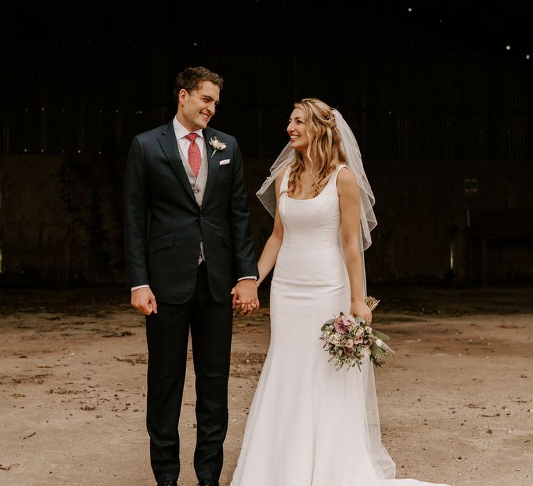 Intimate wedding at Clock Barn with the bride in a fishtail Suzanne Neville wedding dress