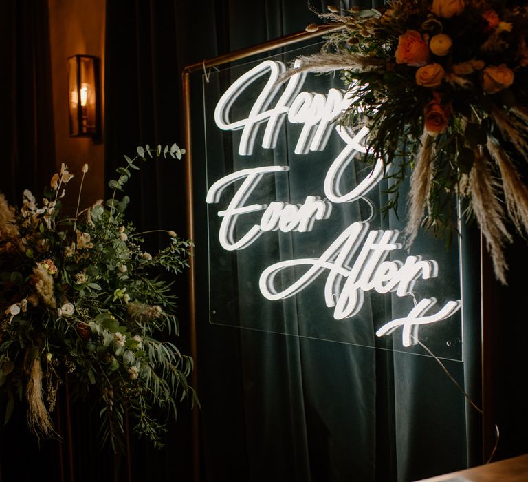 Happily ever after neon sign décor with eucalyptus and pampas grass 