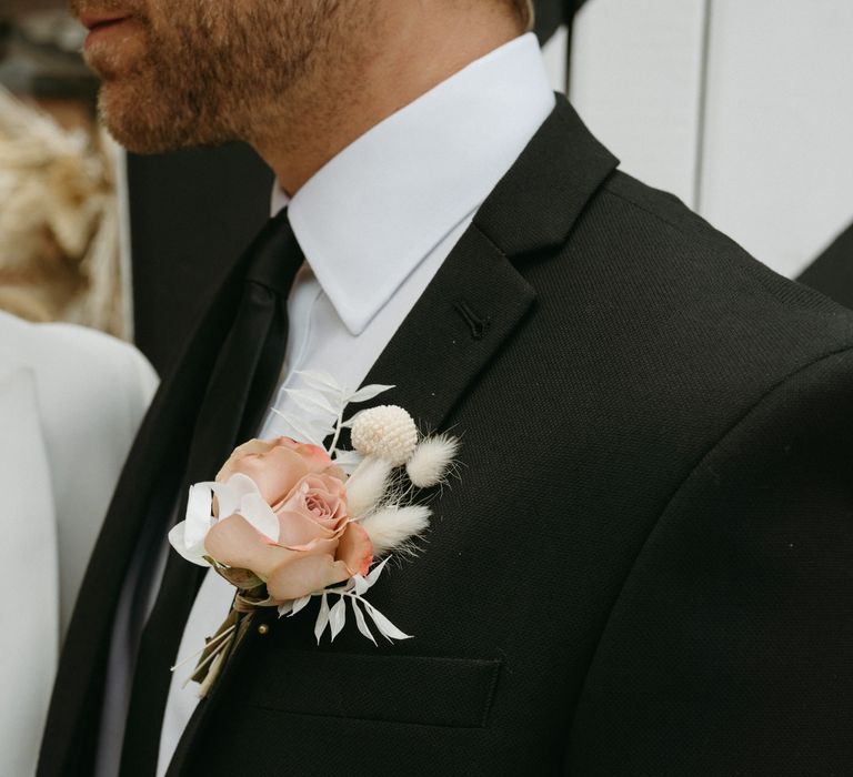 Pink rose buttonhole with dried grasses 