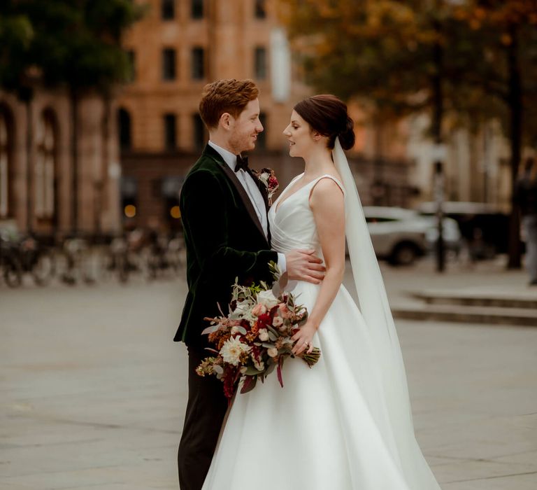 Autumnal wedding in Manchester bride and groom holding each other