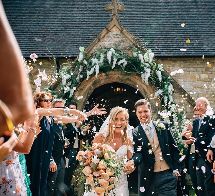 Confetti moment at church countryside wedding