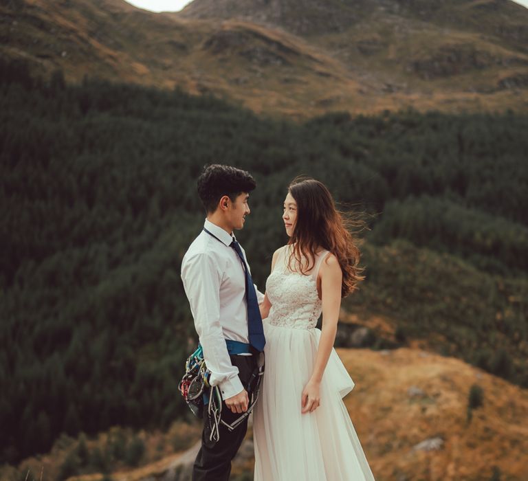 Couple standing on the mountains in Scotland during engagement session