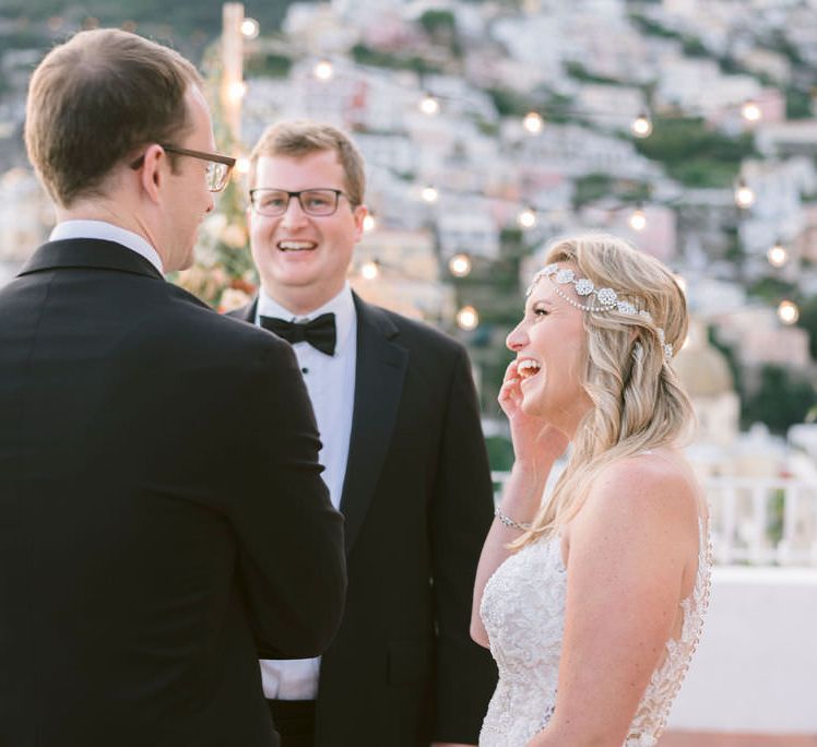 The bride laughing with her two brothers, who officiated the ceremony