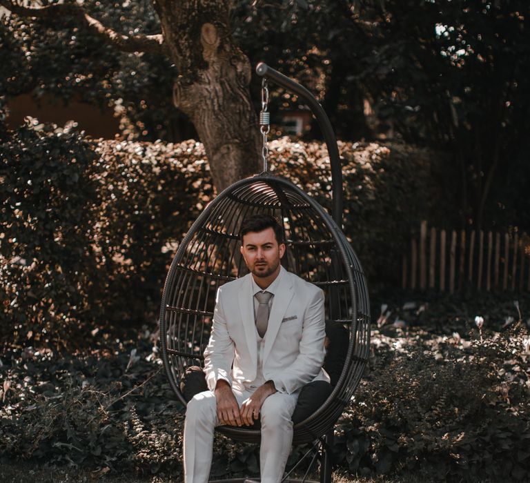 Groom in light grey wedding suit