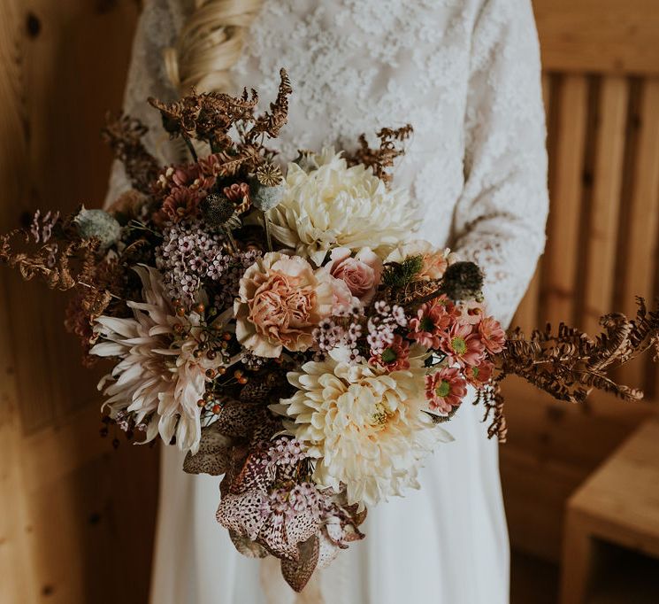 Orange and cream dried and fresh flower autumn wedding bouquet with Dahlias and roses 