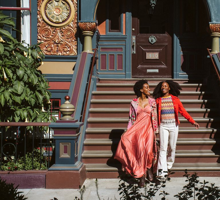 Vibrant San Francisco Engagement Photos in front of a Victorian house in Haight-Ashbury