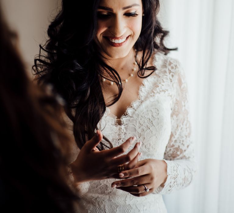 Bride wears her dark hair in full and loose curls