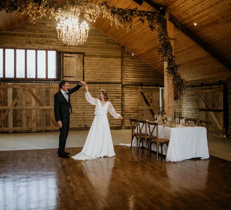 Bride and groom on the dance floor in rustic luxe wedding venue