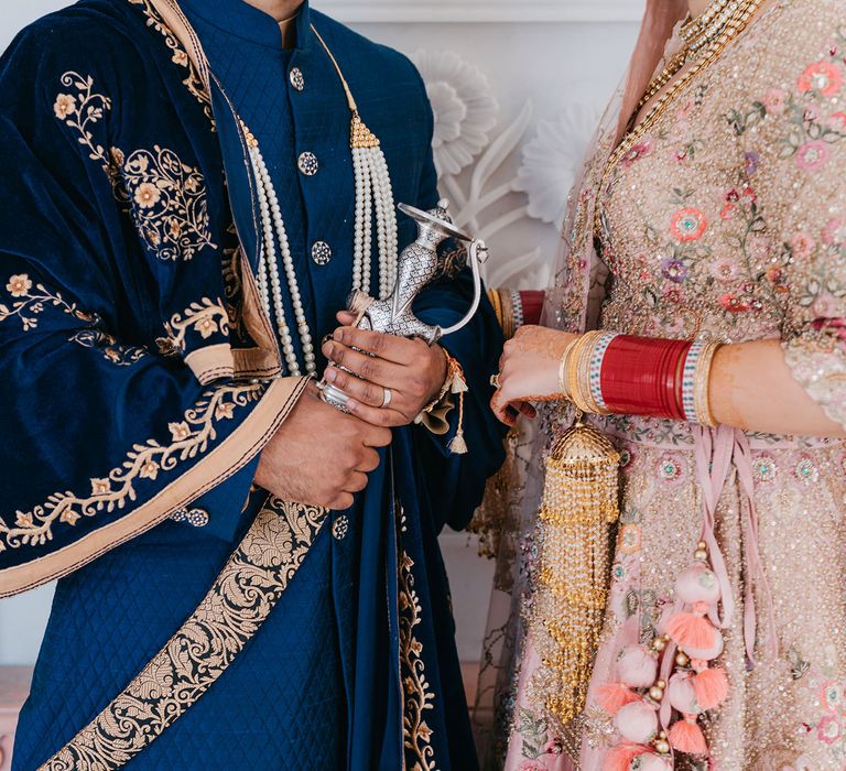 Bride & groom hold hands during wedding ceremony