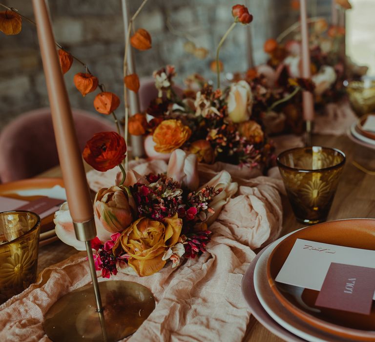 Boho wedding table decor with blush and orange flowers