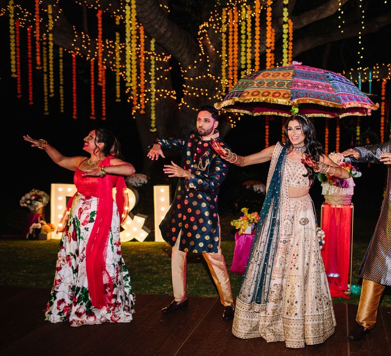 Bride & groom dance outdoors on their wedding day during the sangeet night