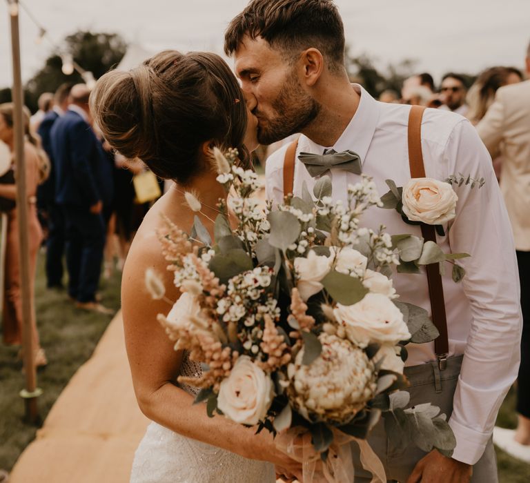 Bride & groom kiss on their wedding day outdoors  | Mark Bamforth Photography