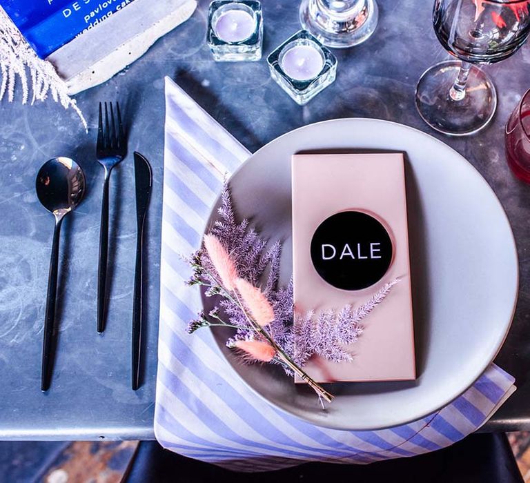 Place setting with strip napkin, pewter cutlery, grey plate and acrylic name place setting 