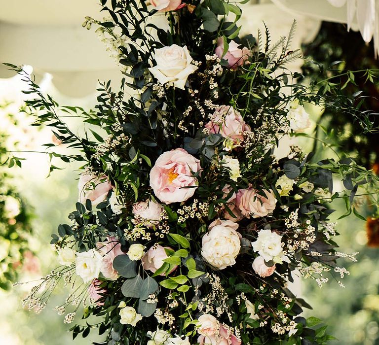 Pink and cream wedding flower displays 