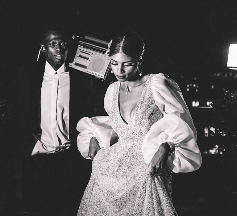 Bride in a sparkly wedding dress with long puff sleeves and groom in a tuxedo at their rooftop intimate Paris wedding elopement 