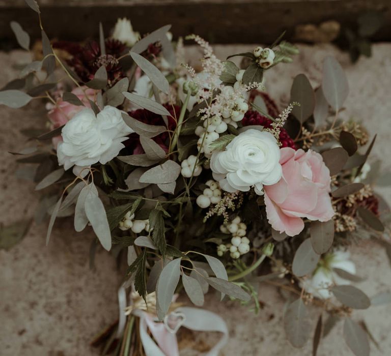 Rustic floral bouquet complete with pastel blooms and green foliage