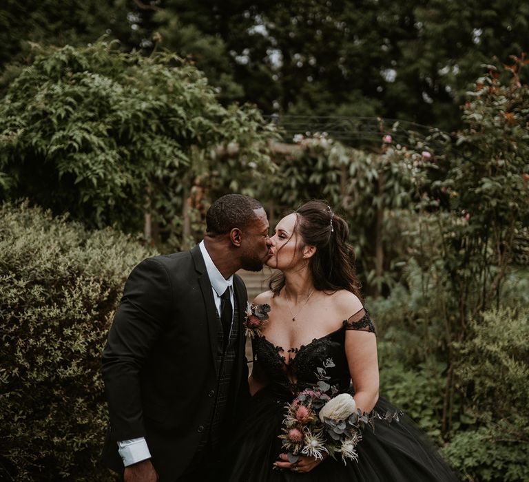 Bride & groom lean into kiss on their wedding day