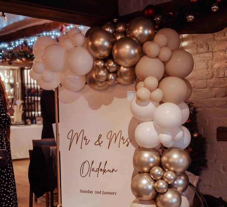 Gold and white balloon arch for wedding reception 