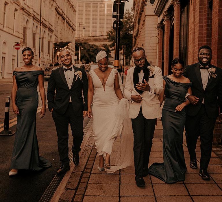 Black tie wedding with wedding party in tuxedo suits and navy bridesmaid dresses 