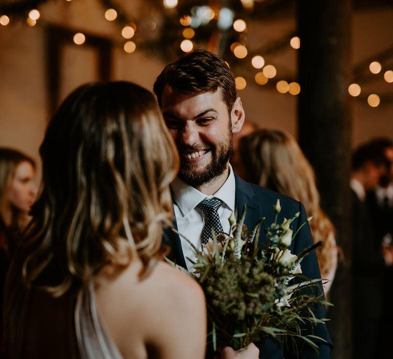 Wedding guests chat on wedding day