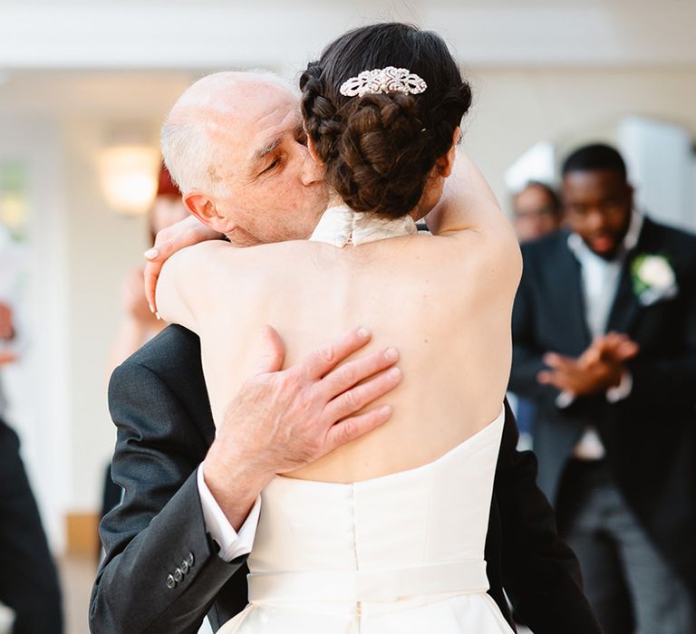 Bride dances with her father in halter neck Jesus Peiro wedding dress with encrusted hair accessory