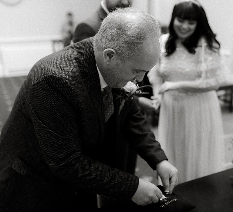 Guest passes the rings over to the bride and groom 